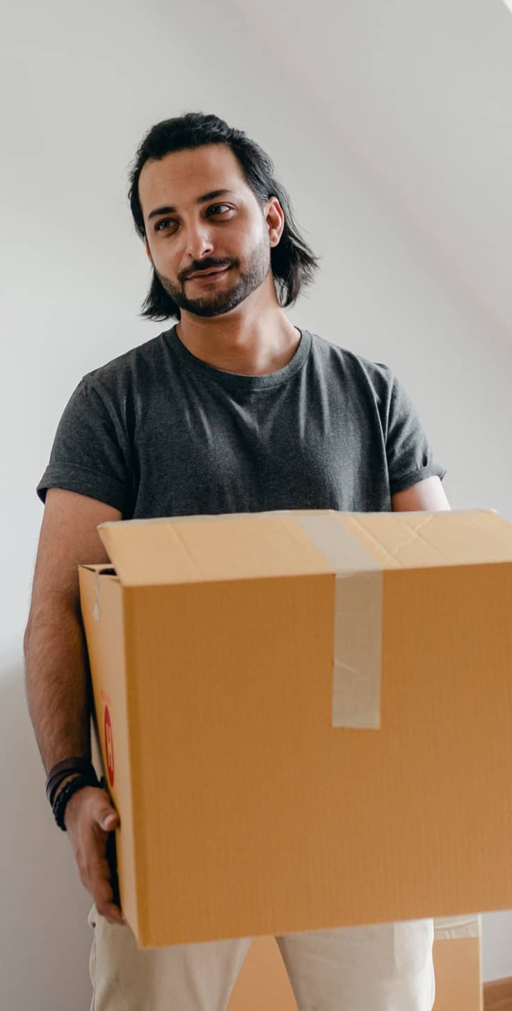 A man carrying a cardboard box